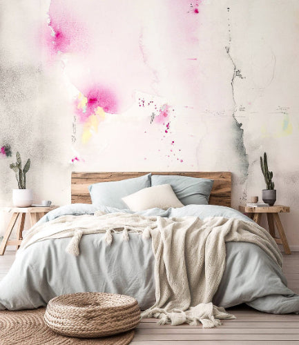 Bedroom with watercolor wall art by dawn trimble art, wooden headboard, and decorative plants.