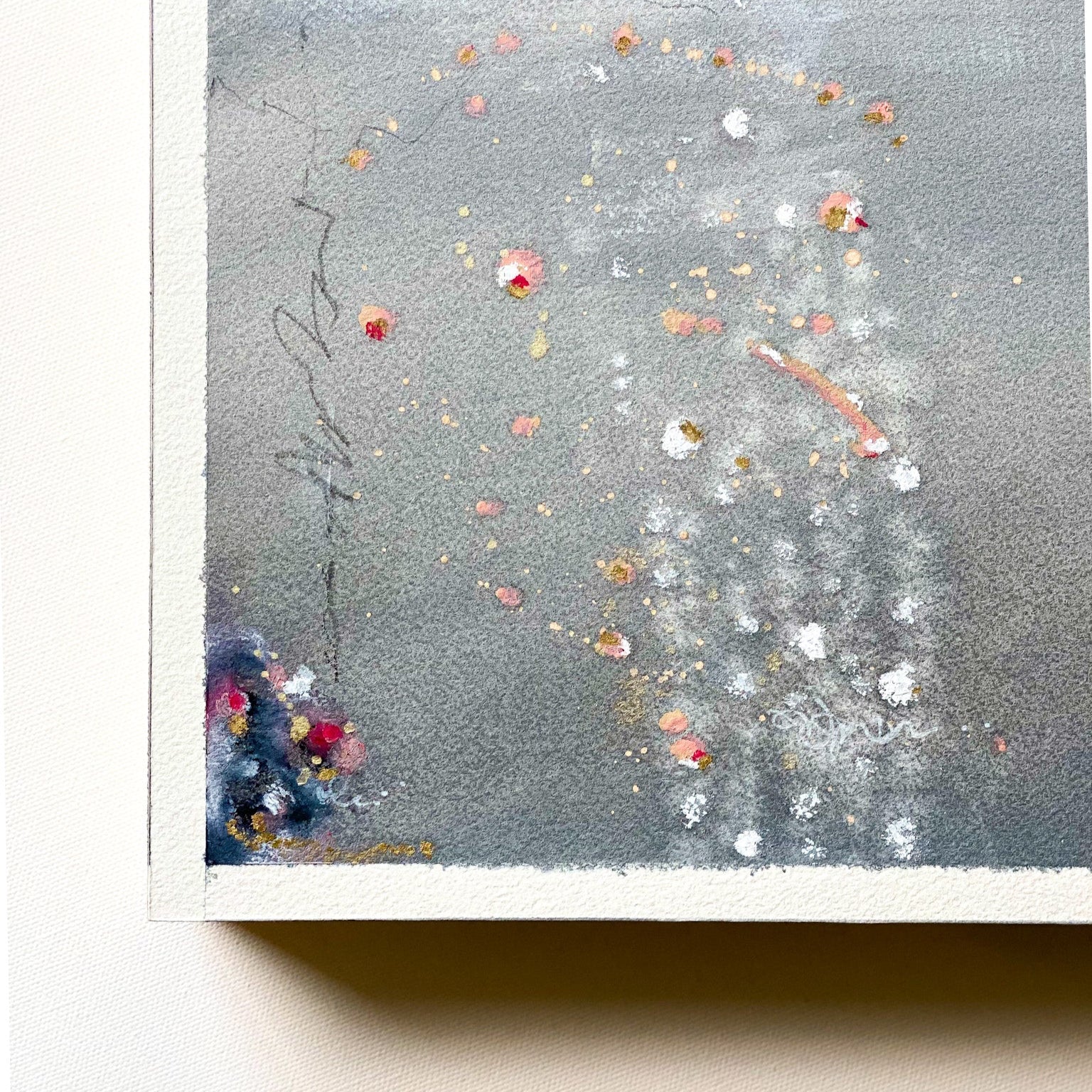 Abstract art piece with splashes of color on a textured gray background