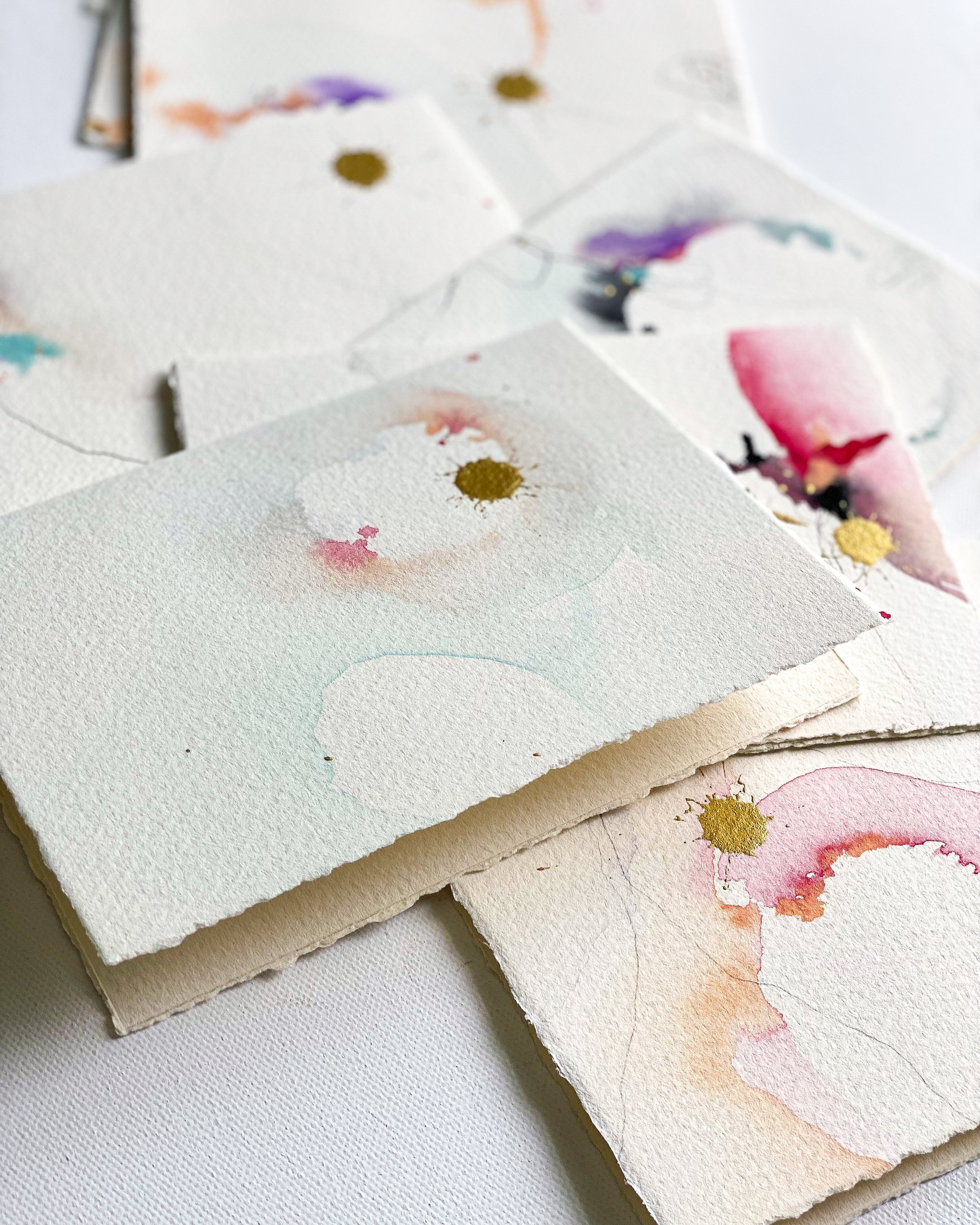 Floral watercolor cards on a white surface