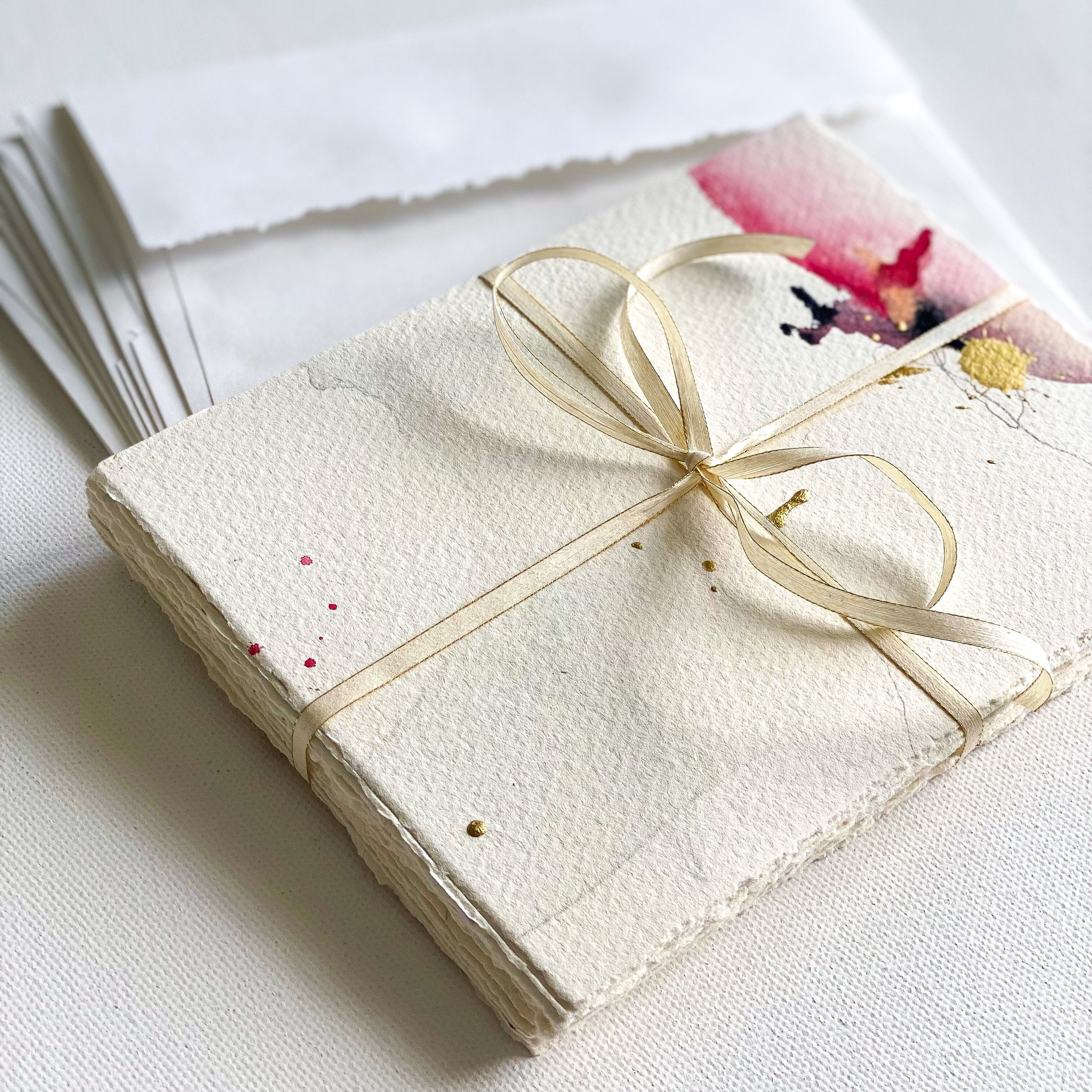 Set of stationery with a floral design and string bow on a white background