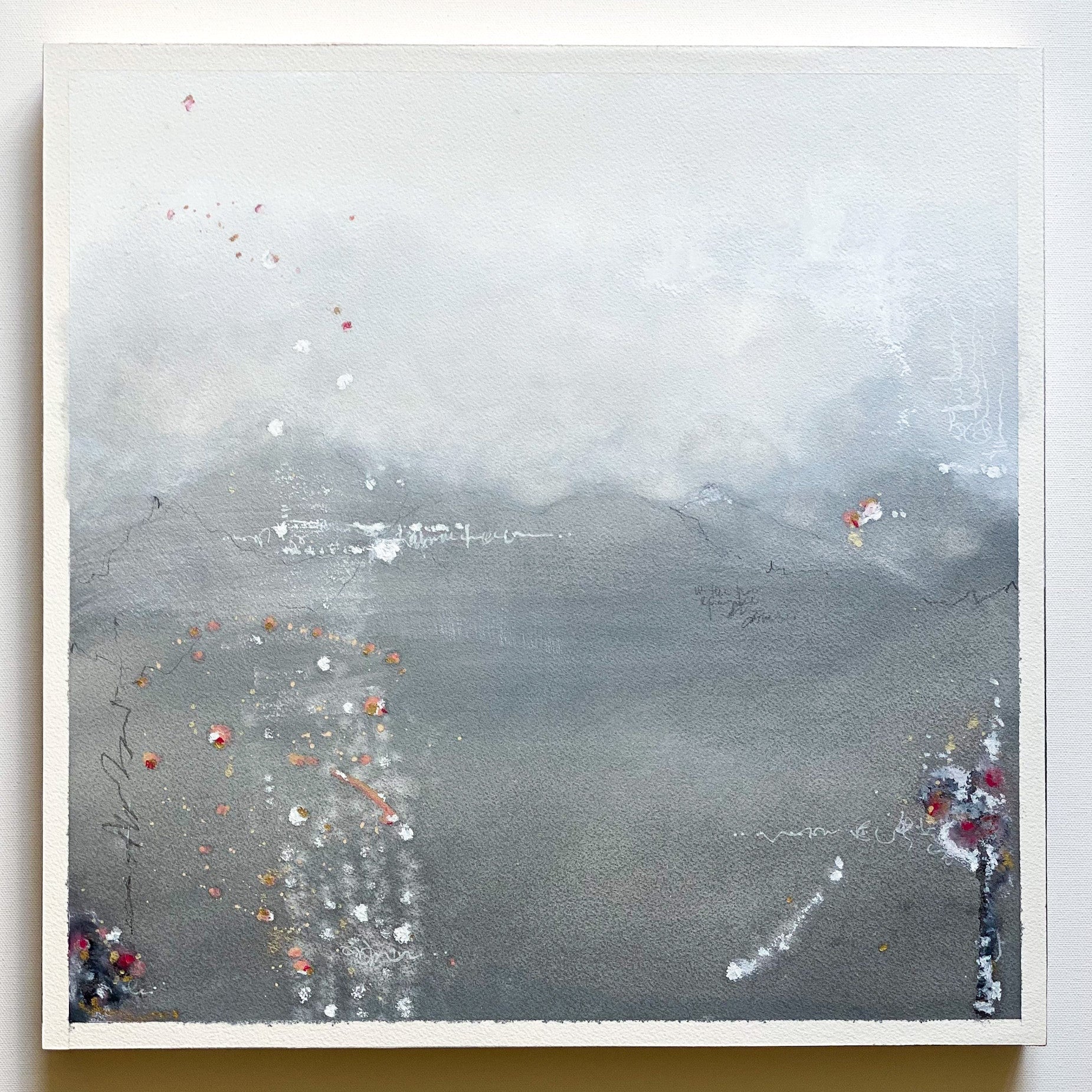 Abstract art piece with gray and white tones and small colorful elements on a white background