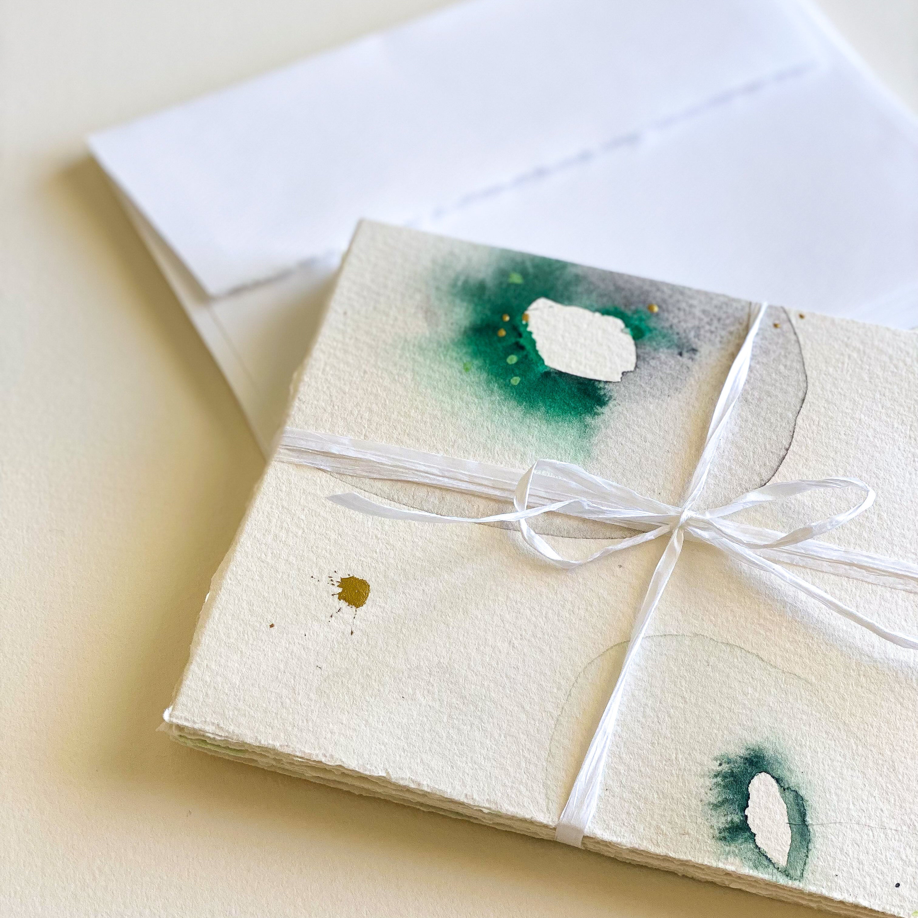 Packaged product with watercolor designs on a white background
