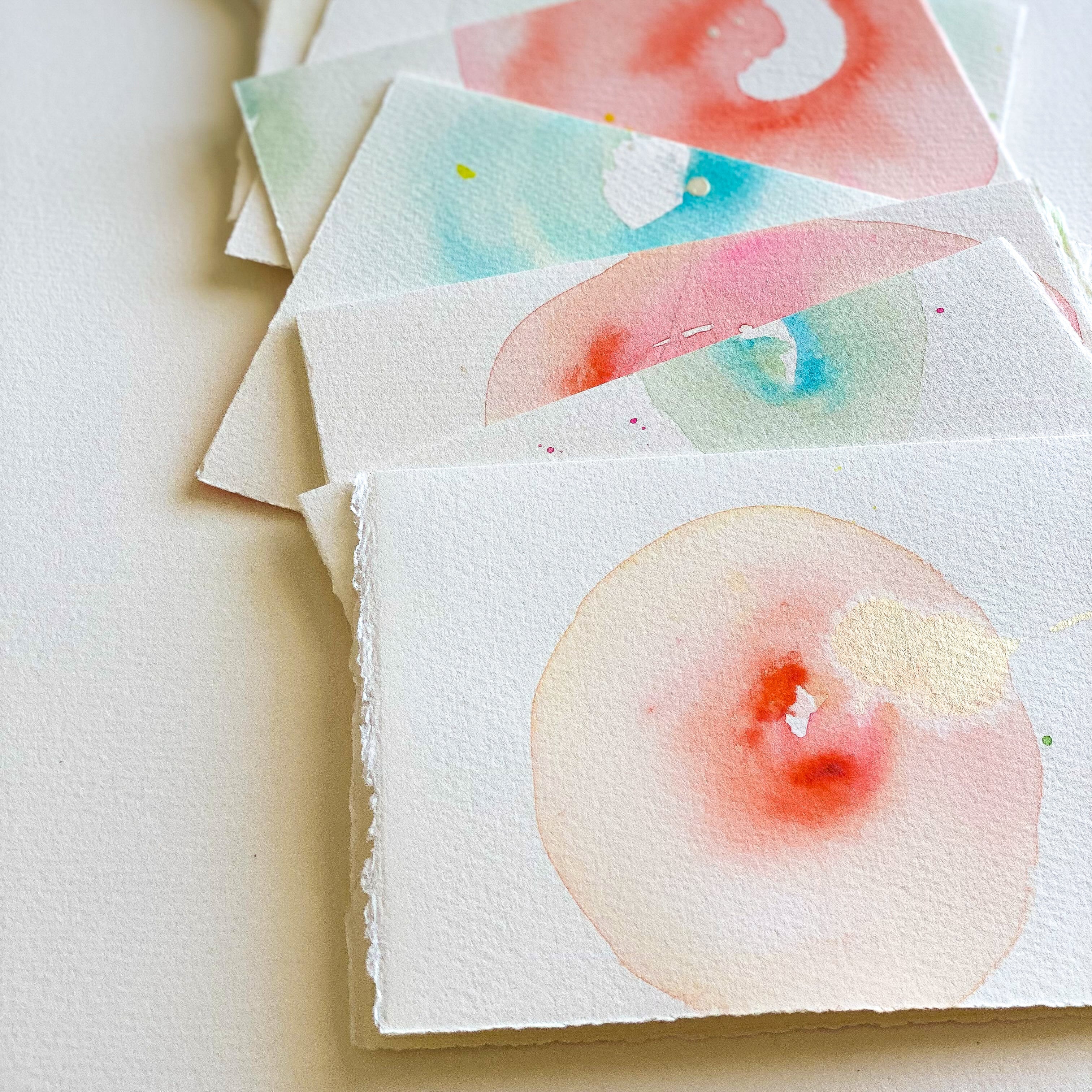 Set of watercolor cards with fruit illustrations on a white surface