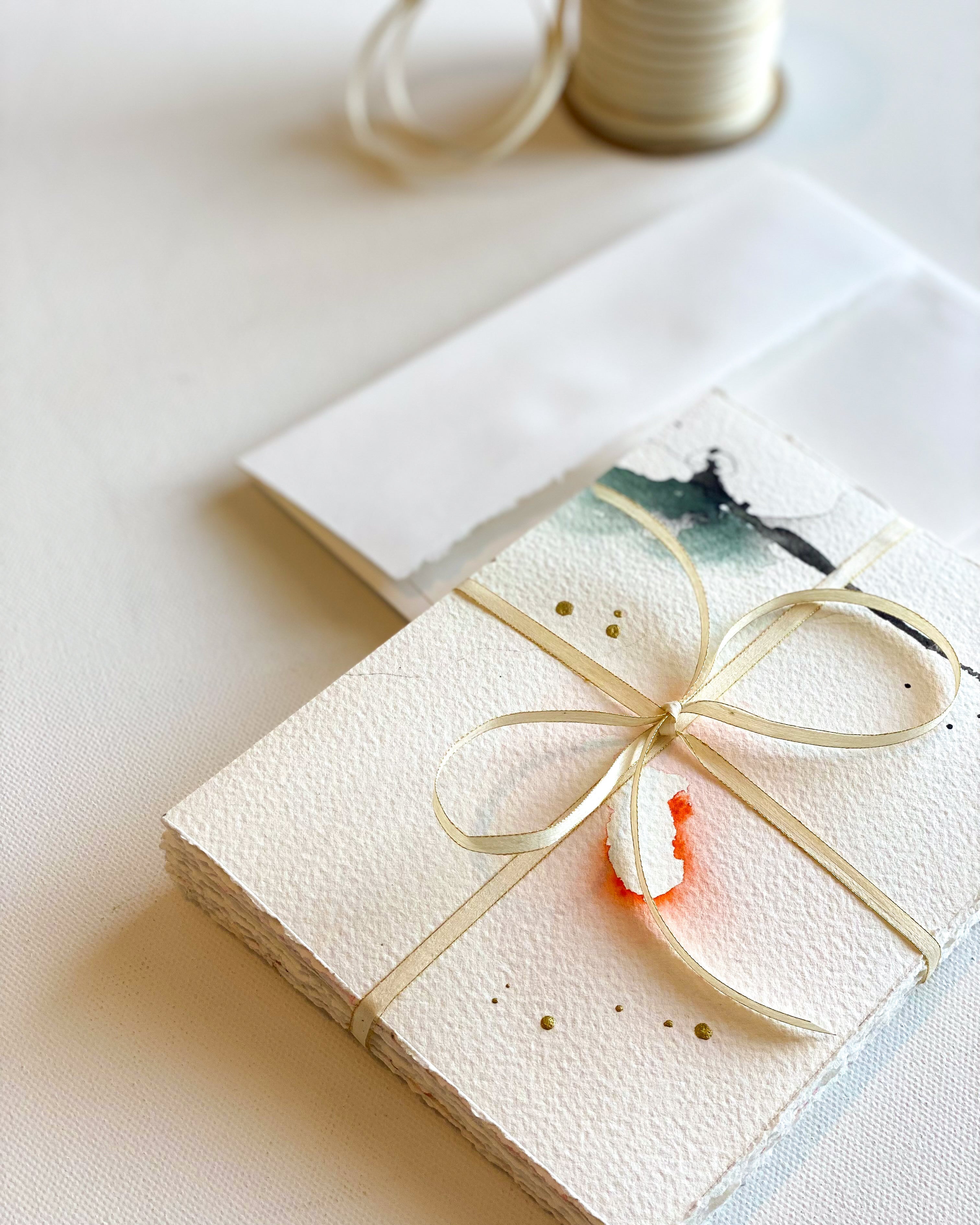 Stationery wrapped with a bow on a light surface