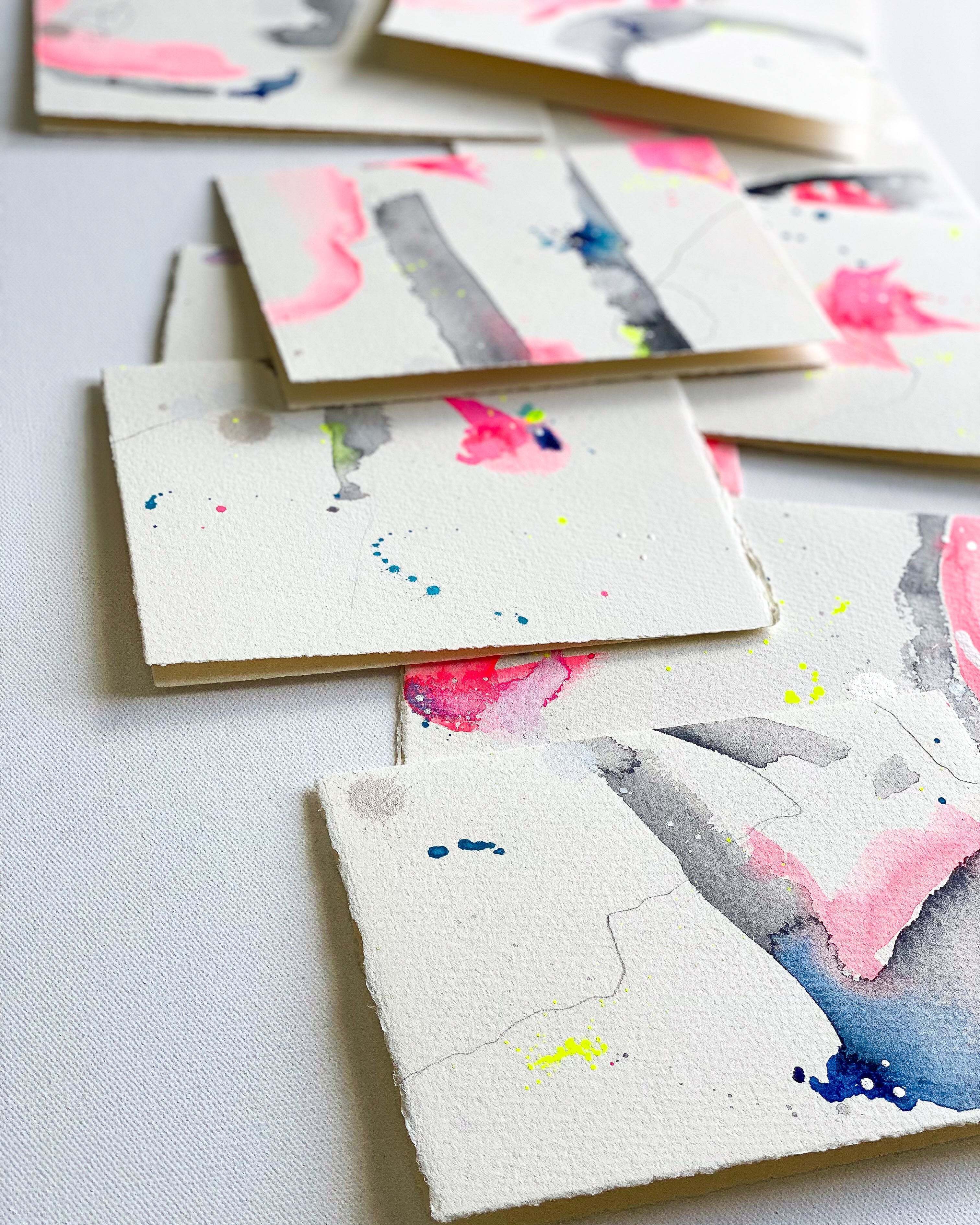 Set of watercolor cards with abstract designs on a light gray background
