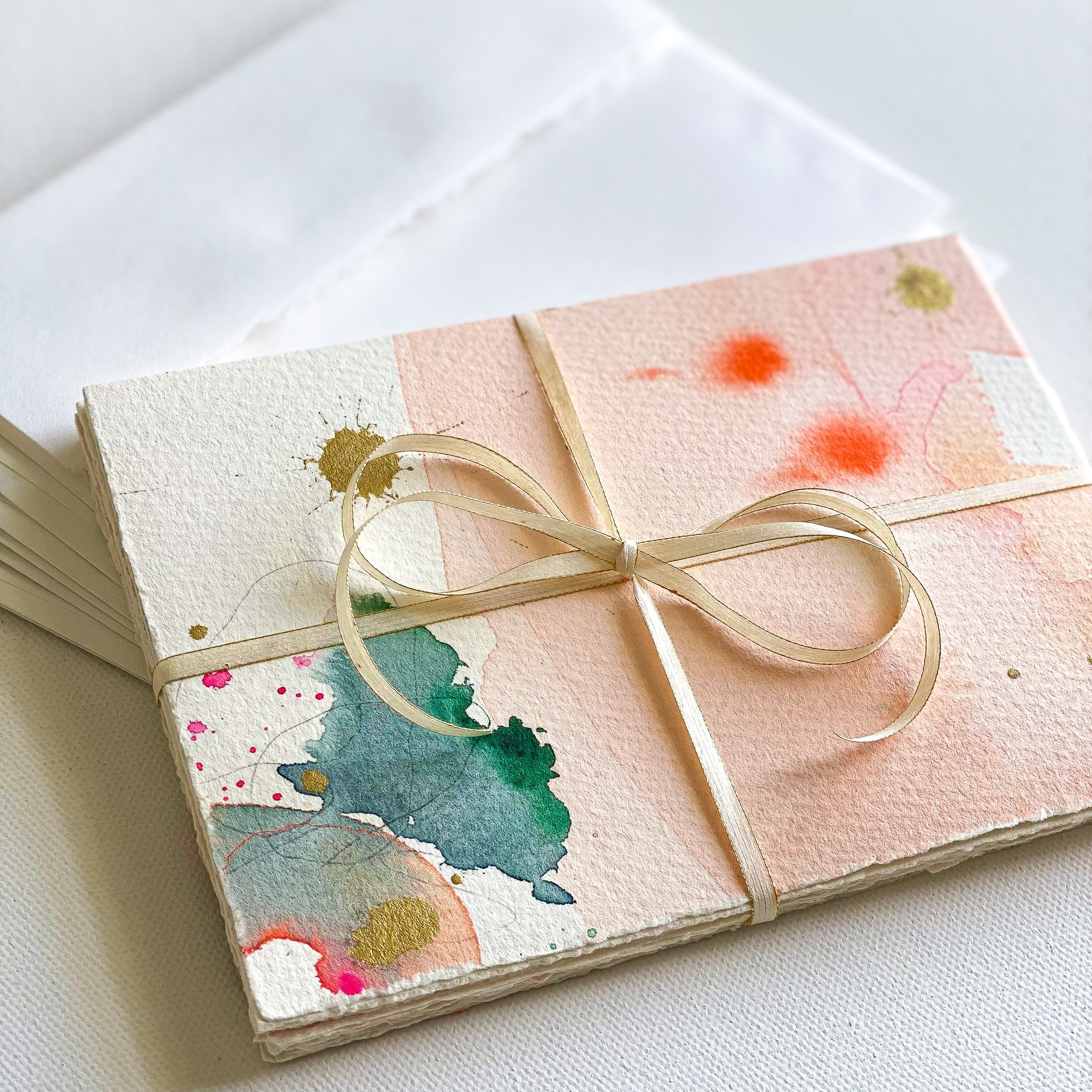 Stationery with watercolor design and a bow on a white background